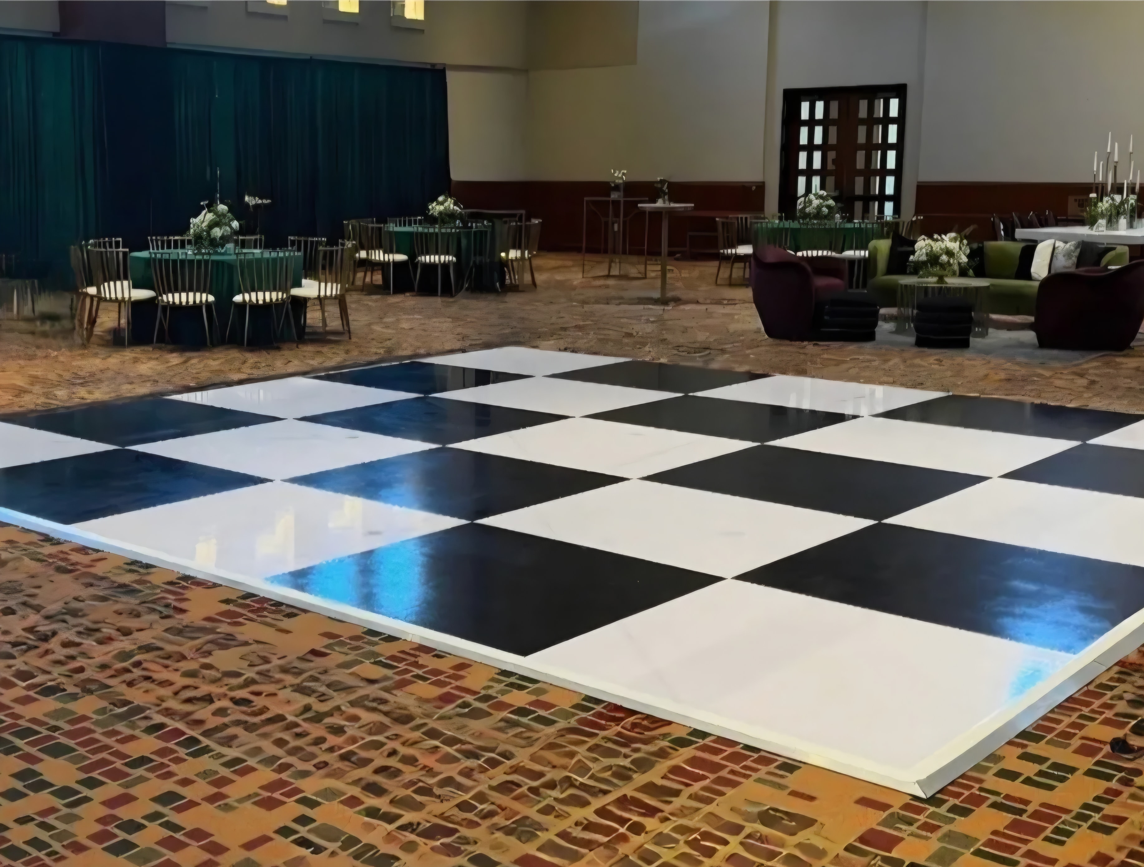 Black and white checkered dance floor installed indoors at event venue
